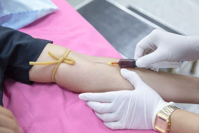 Image of a woman with her blood being drawn